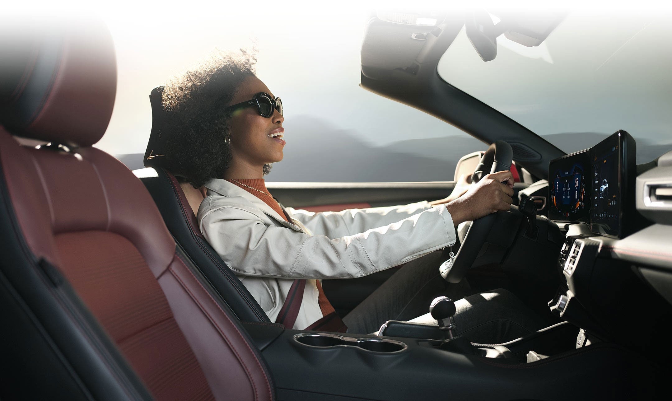 Person sitting in the driver’s seat of a 2024 Ford Mustang® convertible | Way Scarff Ford Auburn in Auburn WA