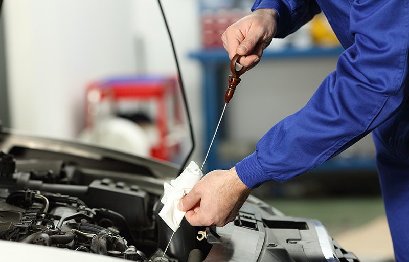 Technician performing oil change