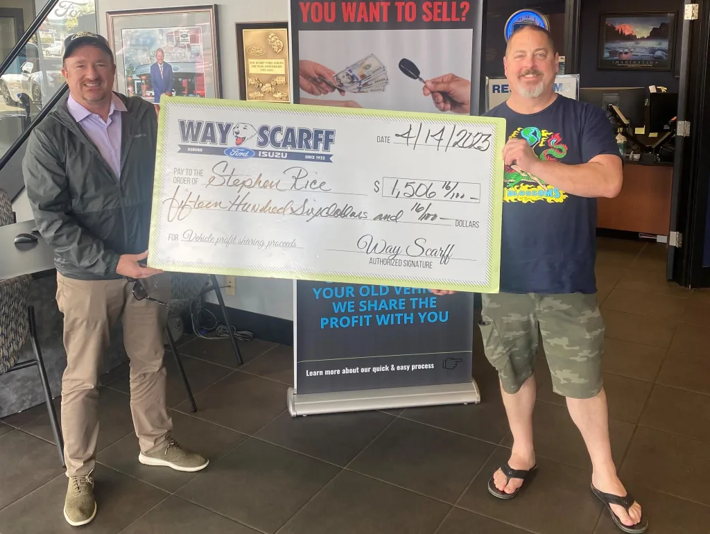 two mens with new vehicles.webp