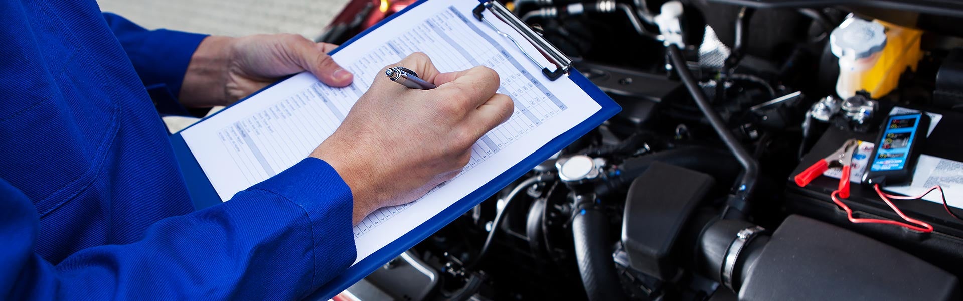 Photo of technician with clipboard of checklist for car maintenance
